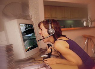 A girl playing games and screaming in front of a computer screen