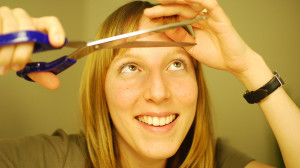 A nice girl cutting her hair