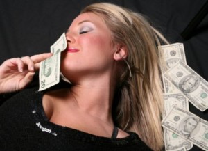 A beautiful above banknotes girl sniffing money