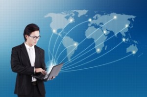 A man connecting to the world map with a laptop