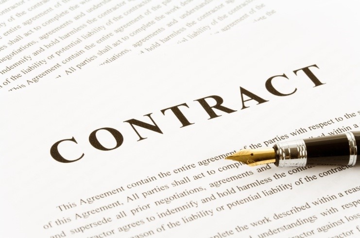 "CONTRACT" word written on a paper with a pen